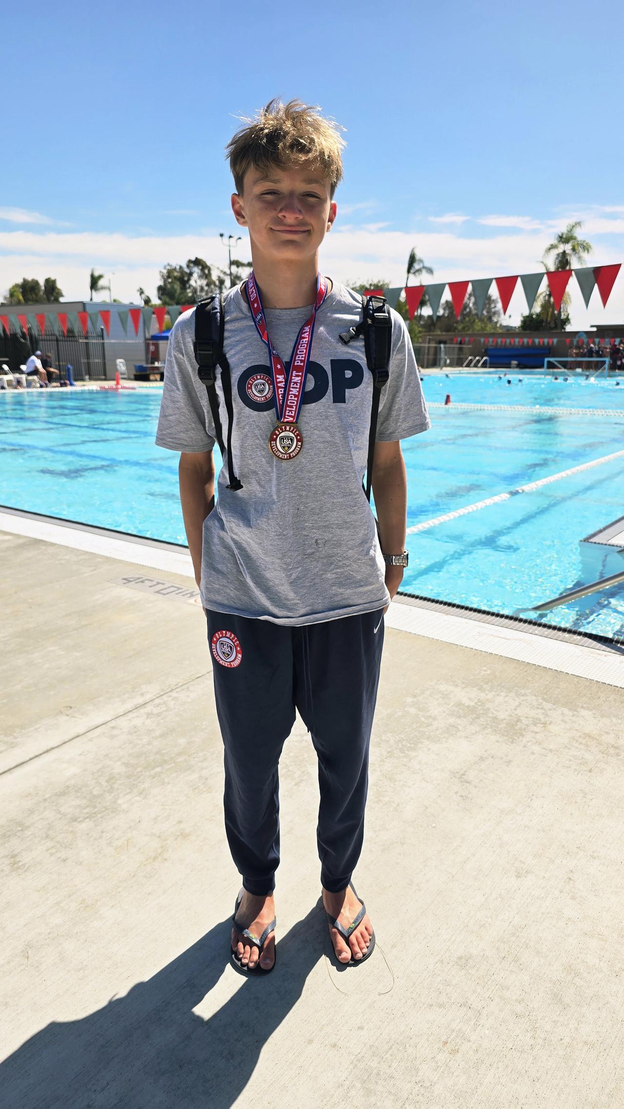 Simon Vasquez at the pool wearing his ODP medal